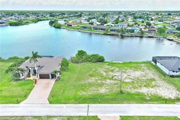 Aerial perspective of suburban area with a nearby body of water