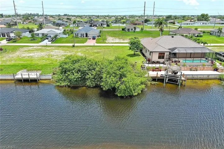 Aerial perspective of suburban area with a nearby body of water