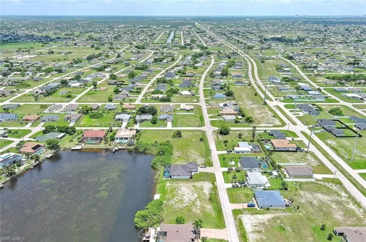 Aerial view of property's location featuring nearby suburban area and a nearby body of water
