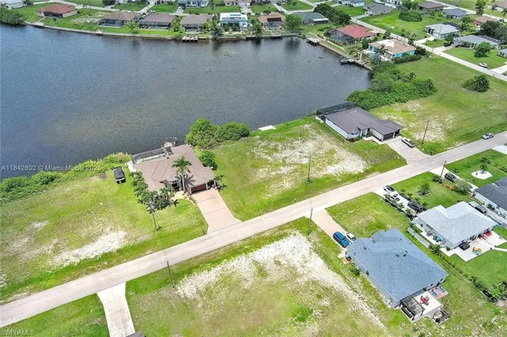 Aerial overview of property's location with a large body of water and nearby suburban area