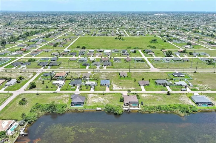 Aerial view of property's location featuring nearby suburban area