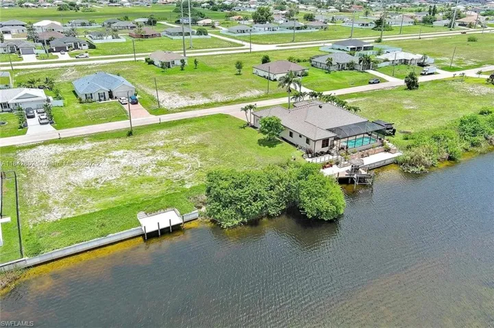 Aerial view of residential area featuring a large body of water