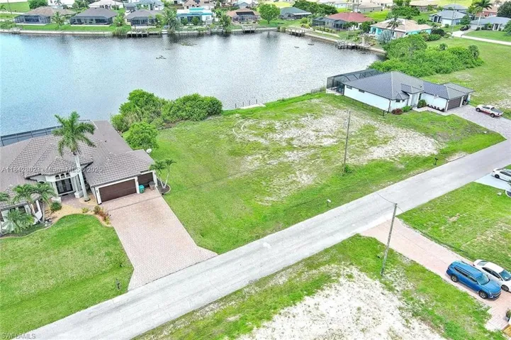 Aerial view of residential area featuring a nearby body of water