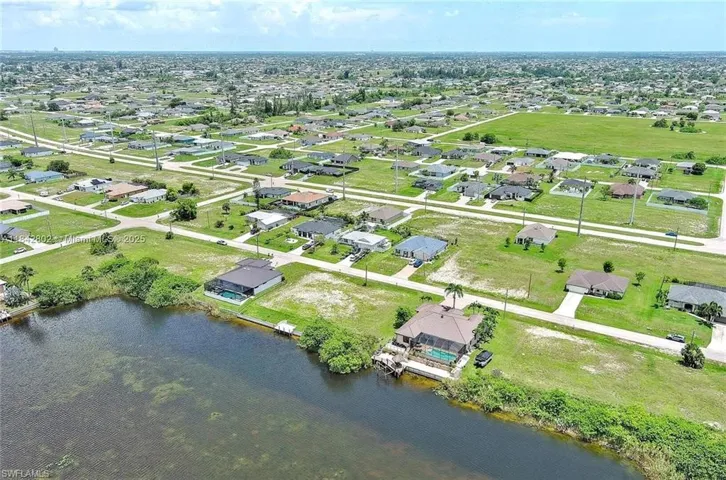 Aerial overview of property's location with a large body of water and nearby suburban area