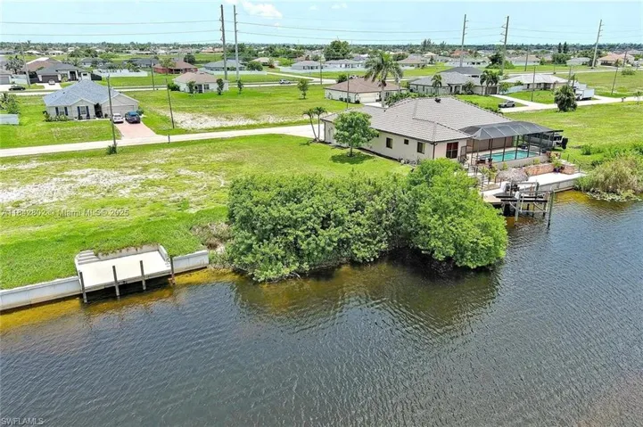Aerial perspective of suburban area with a large body of water