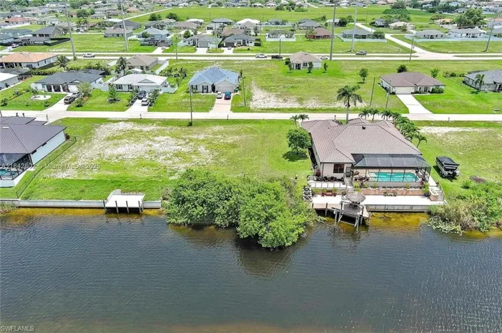 Aerial view of residential area featuring a large body of water