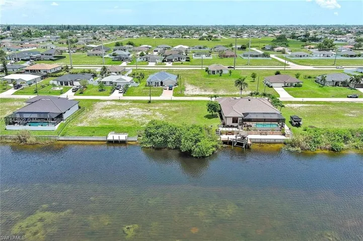 Aerial perspective of suburban area with a large body of water