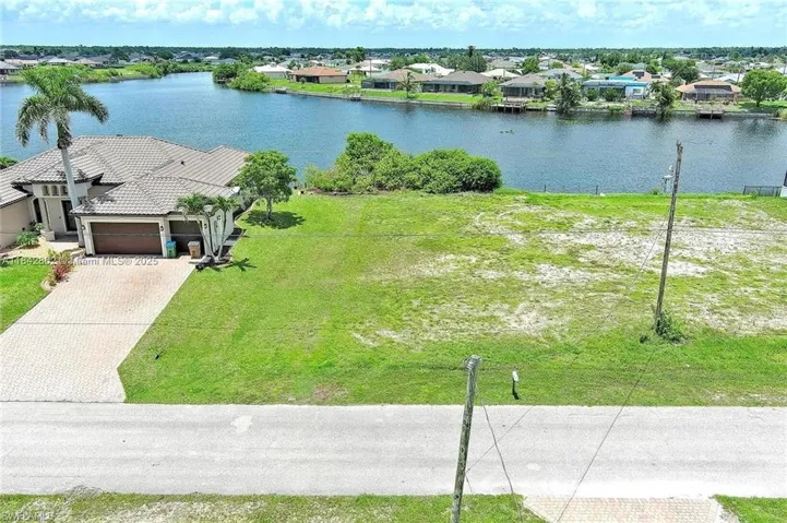 Aerial view of residential area featuring a large body of water