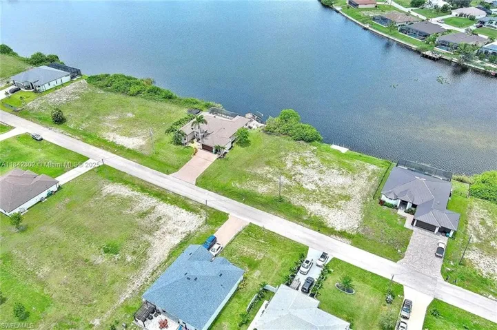 Aerial perspective of suburban area featuring a large body of water