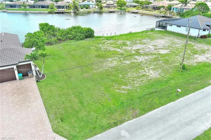 Aerial view of residential area featuring a nearby body of water