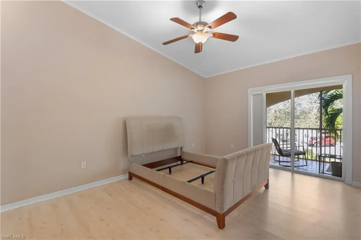 Bedroom with access to exterior, light wood-type flooring, and crown molding