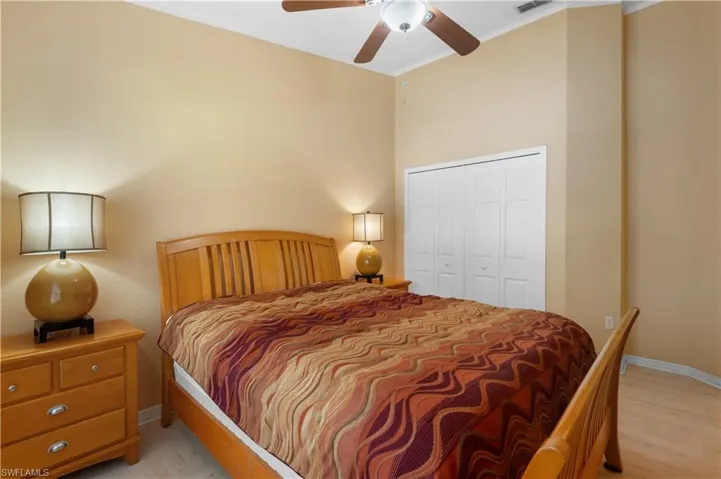 Bedroom featuring a closet, light hardwood / wood-style flooring, ceiling fan, and crown molding
