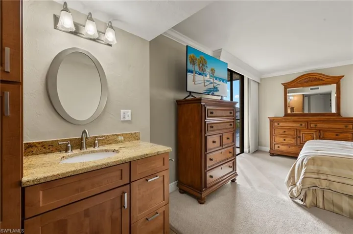 Bathroom with vanity and ornamental molding