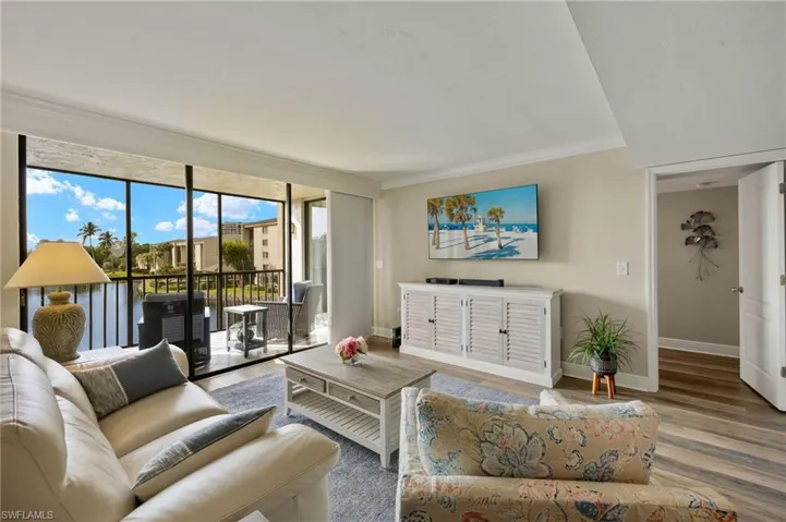 Living room featuring crown molding and wood-type flooring