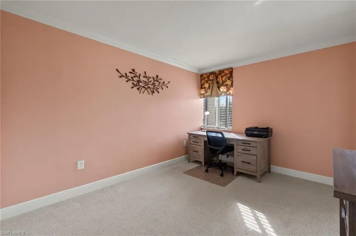 Carpeted office with ornamental molding