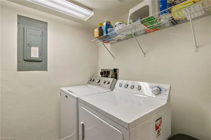 Laundry room featuring washer and dryer and electric panel