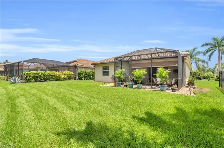 View of yard with a patio area and glass enclosure