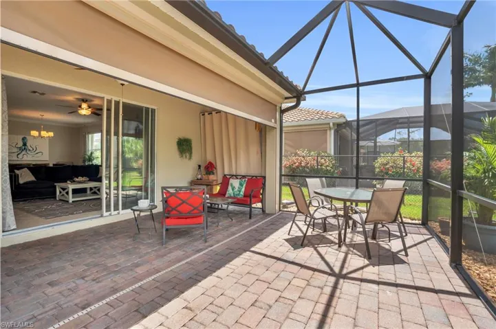 Sunroom / solarium with ceiling fan with notable chandelier