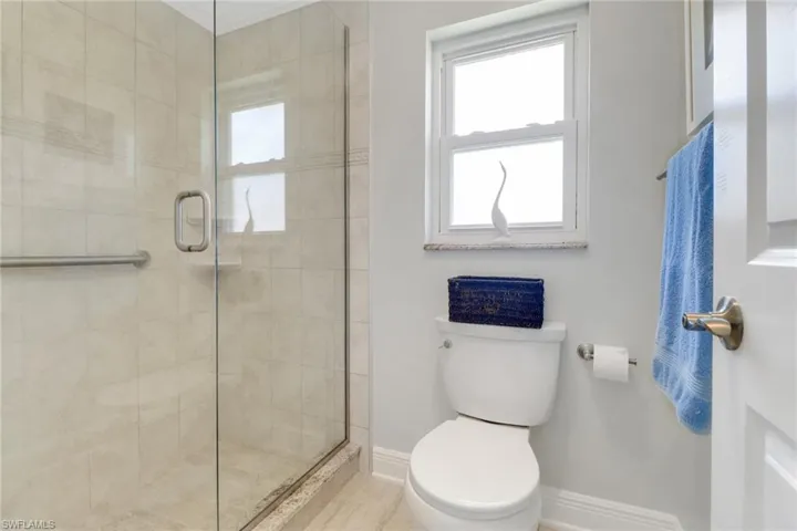 Bathroom with a stall shower and toilet