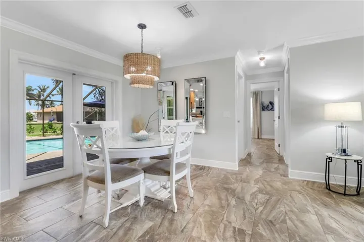Dining area with crown molding and french doors