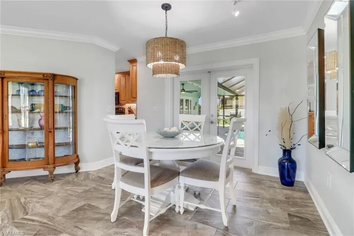 Dining area featuring crown molding, french doors, and a ceiling fan