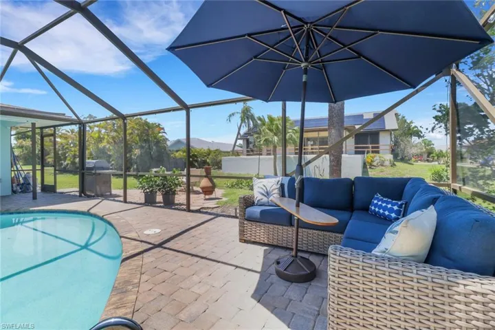 View of patio / terrace with a lanai, a sunroom, an outdoor pool, and an outdoor lounge area