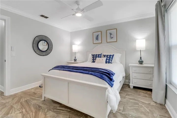 Bedroom featuring crown molding and a ceiling fan