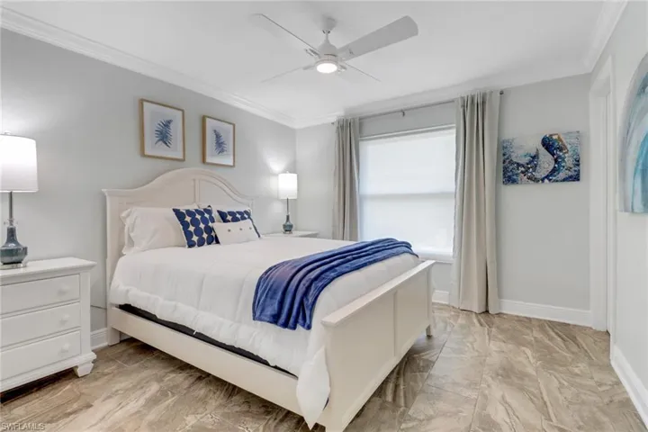 Bedroom with crown molding and ceiling fan