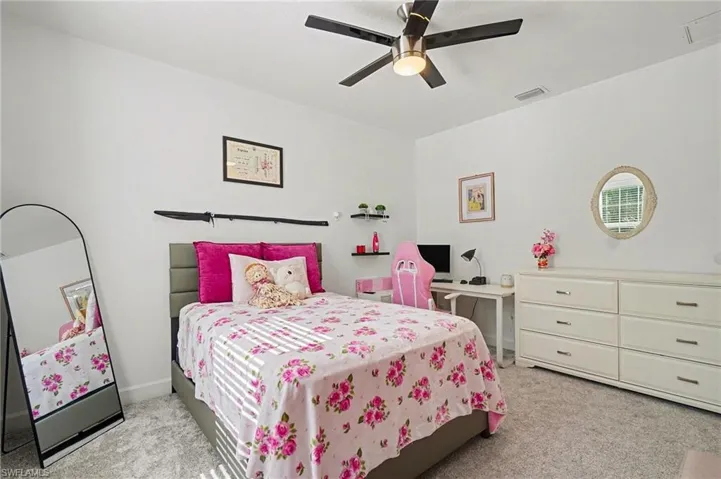 Bedroom featuring light colored carpet and ceiling fan