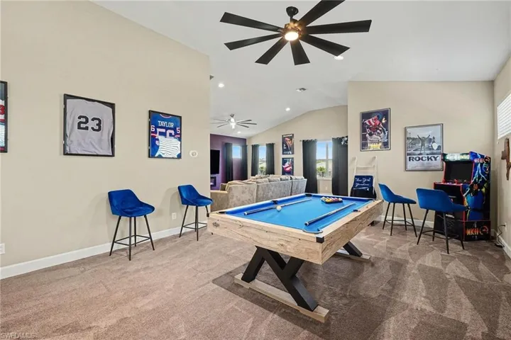 Game room featuring billiards, light colored carpet, vaulted ceiling, and a ceiling fan
