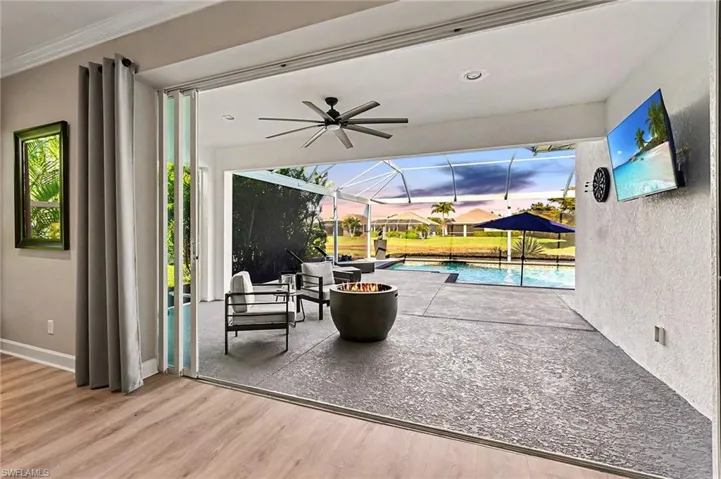 Expansive outdoor living area featuring a screened-in patio, swimming pool, and water frontage
