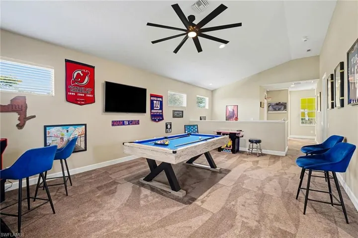Game room featuring billiards, healthy amount of natural light, light colored carpet, vaulted ceiling, and ceiling fan
