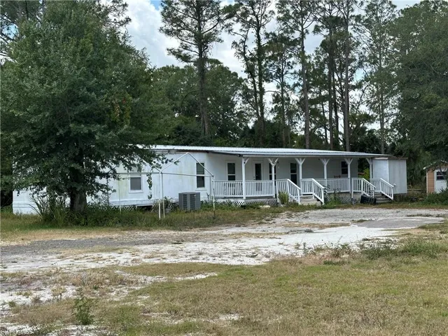 View of front of home featuring covered Deck
