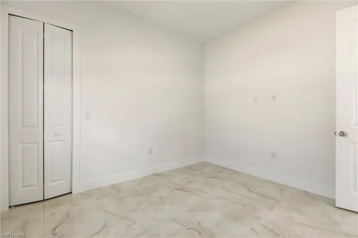 Unfurnished bedroom with baseboards