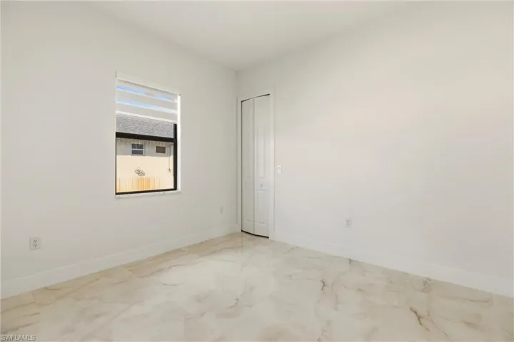 Spare room with baseboards and light marble finish flooring
