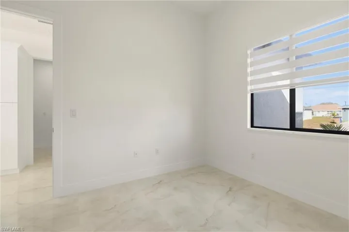 Spare room featuring light marble finish flooring