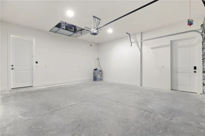 Garage with water heater and a garage door opener