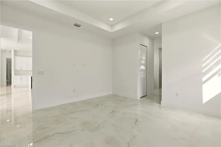 Unfurnished room featuring recessed lighting and light marble finish flooring