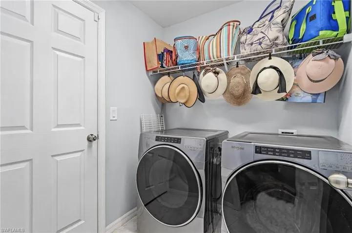 Laundry area with separate washer and dryer and baseboards