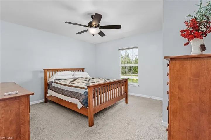 Bedroom featuring light carpet and ceiling fan