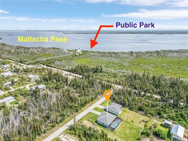 Aerial view of property and surrounding area with a large body of water