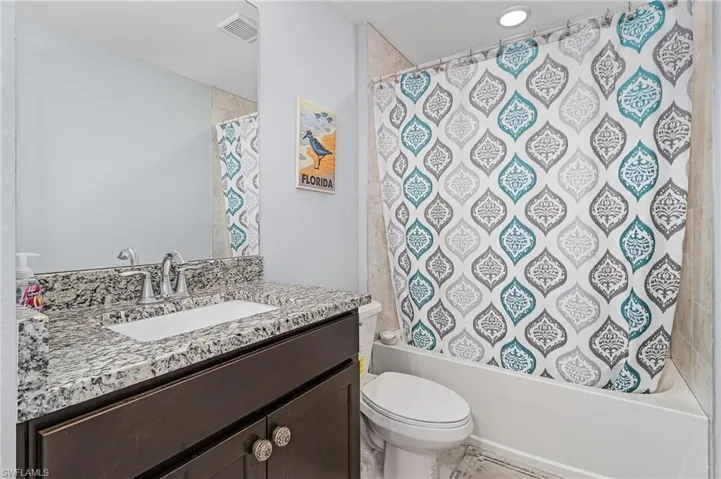 Bathroom with vanity and shower / bath combo