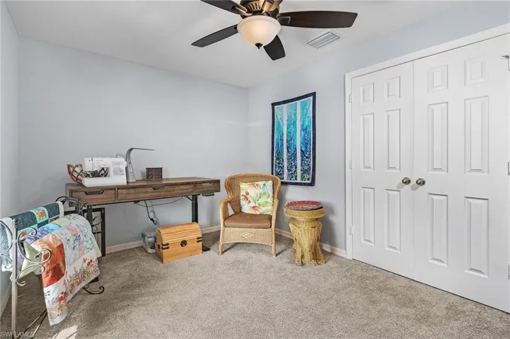 Bedroom with carpet floors, closet, and a ceiling fan