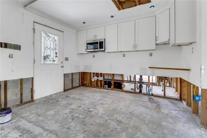 Kitchen featuring white cabinetry