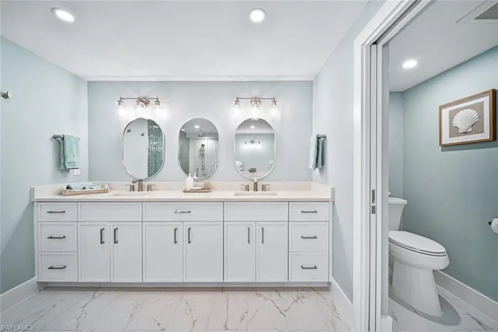 Bathroom with tile flooring and dual bowl vanity