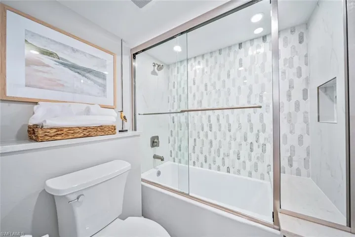 Bathroom with enclosed tub / shower combo