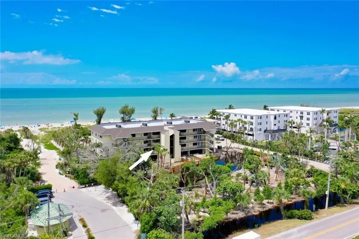 Birds eye view of property with a water view