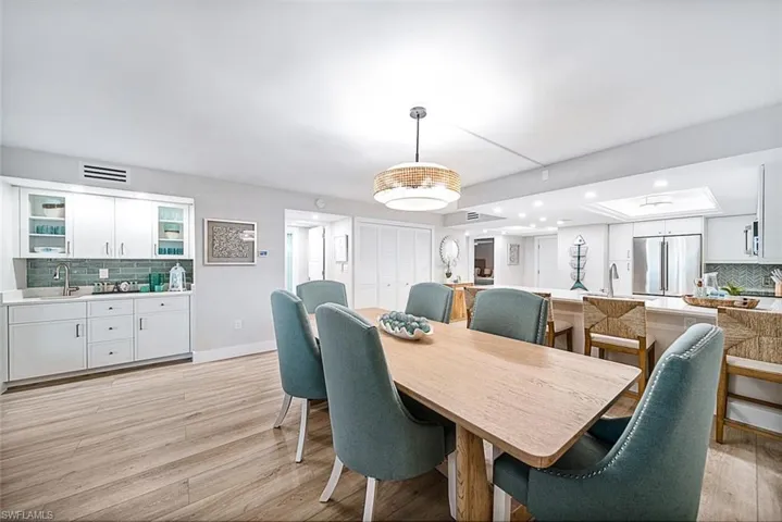 Dining room featuring sink and light hardwood / wood-style flooring