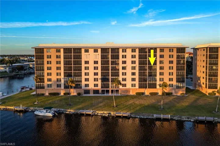 View of apartment building / complex featuring a water view