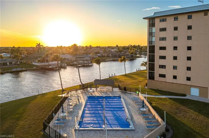Dock featuring a water view, a yard, and a patio area